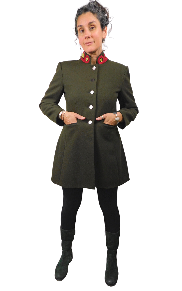 Person wearing a green coat with buttons on a white background