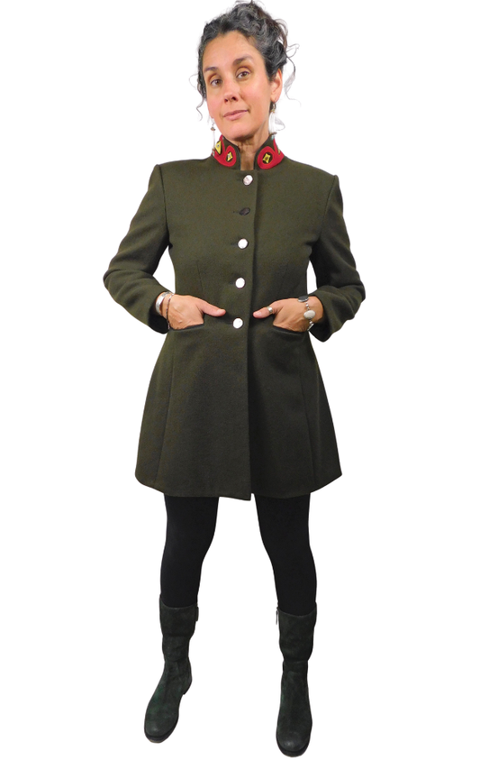 Person wearing a green coat with buttons on a white background