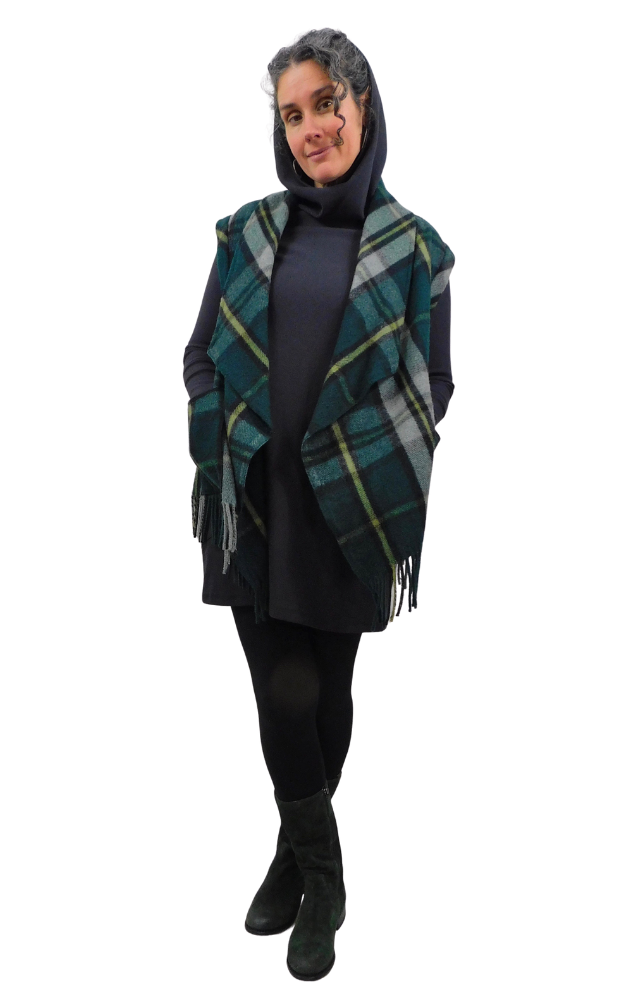 Person wearing a plaid vest over a dark outfit on a white background