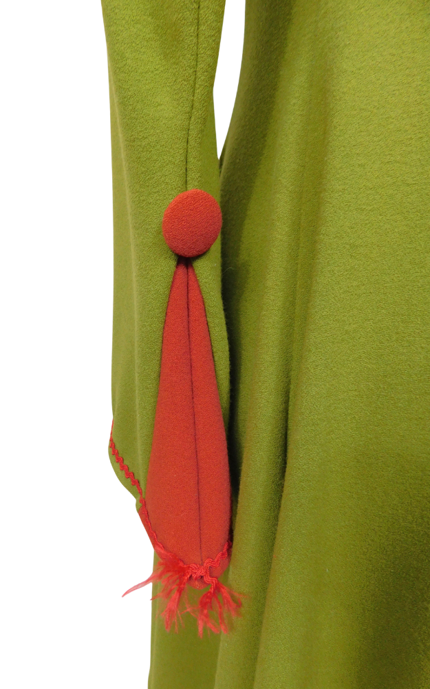 Green garment sleeve with red detail on a white background