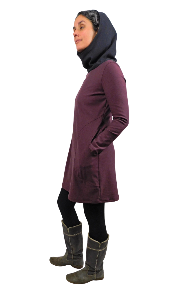 Person wearing a maroon dress with a black hood and dark boots on a white background