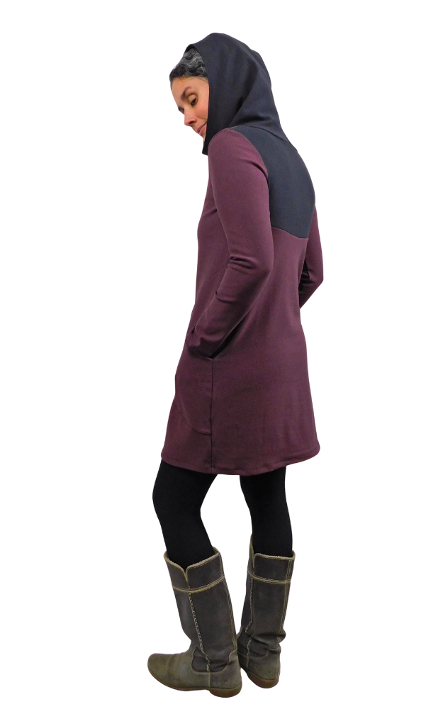 Person wearing a wine-colored tunic with a black hood on a white background