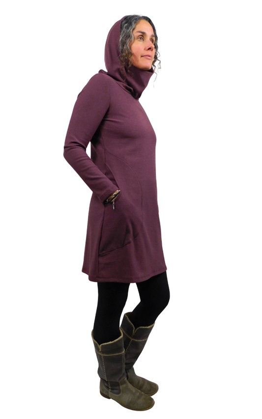 Person wearing a long wine-coloured hoodie with a hood on a white background