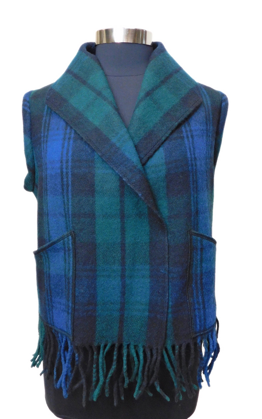 Blue, green & black tartan vest with fringes on a mannequin against a white background