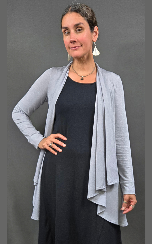 Half figure of woman wearing cardigan open at front