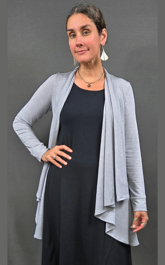 Half figure of woman wearing cardigan open at front