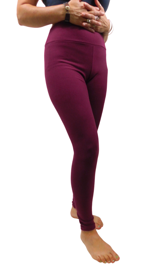 A person wearing high-waisted leggings in a deep burgundy wine color, shown from the waist down against a plain white background.