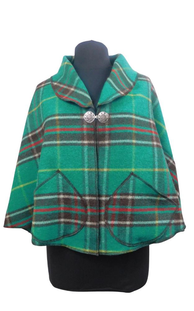 Green tartan plaid cape on a mannequin against a white background