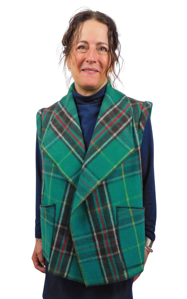 Woman wearing a green tartan vest on a white background