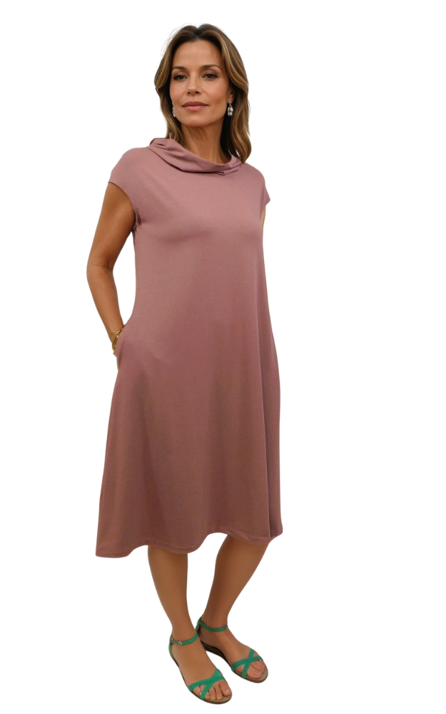 Woman wearing a nutmeg pink dress on a white background