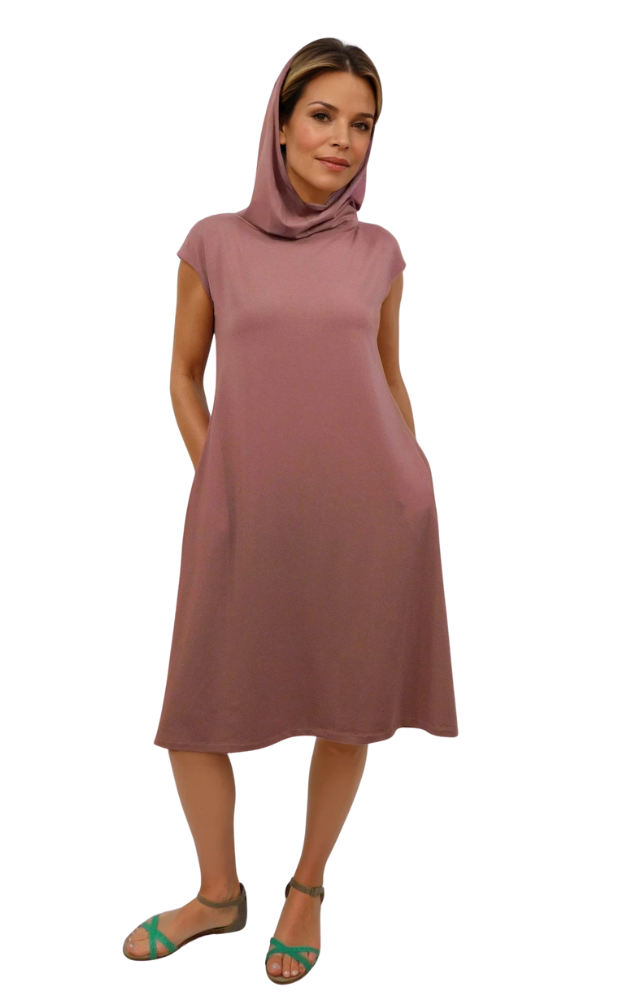 Woman wearing a sleeveless pinkish brown dress with a hood on a white background