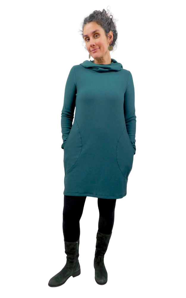 Person wearing a pine green dress with a hood on a white background