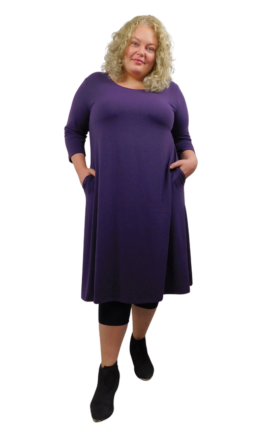 Woman wearing a purple dress with a white background