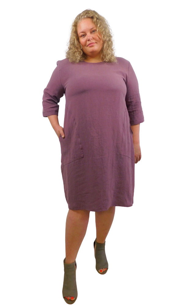 Woman wearing a purple dress against a white background