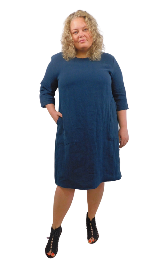 Woman wearing a dark blue dress against a white background