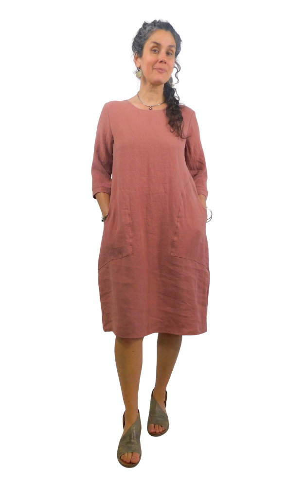 Woman wearing a pink/brown dress on a white background