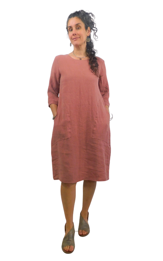 Woman wearing a pink/brown dress on a white background