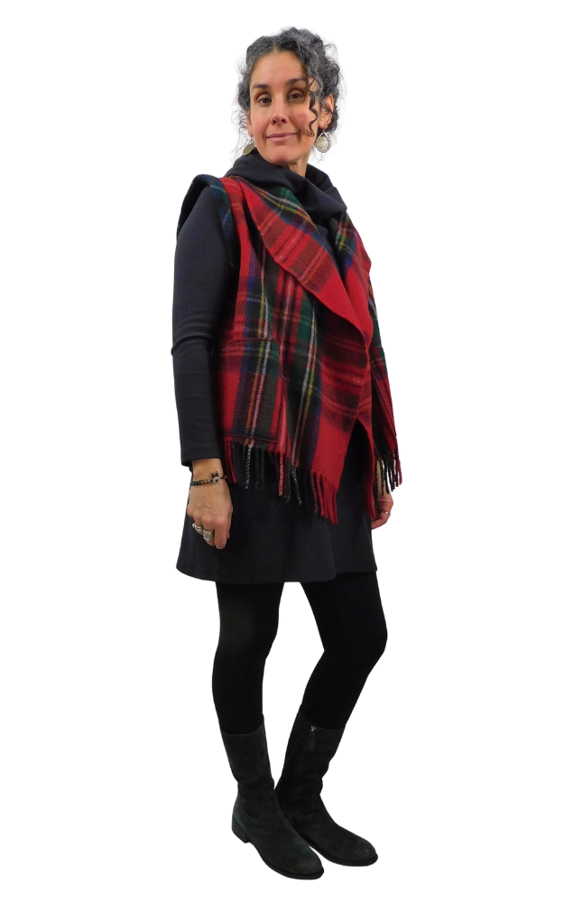 Woman wearing a red tartan vest and black outfit on a white background