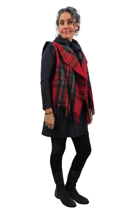 Woman wearing a red tartan vest and black outfit on a white background