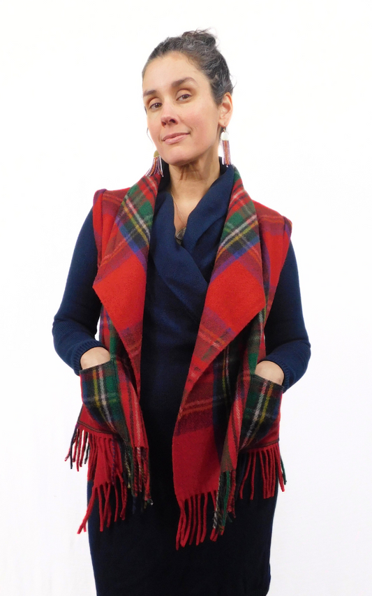 Woman wearing a red tartan vest with fringe