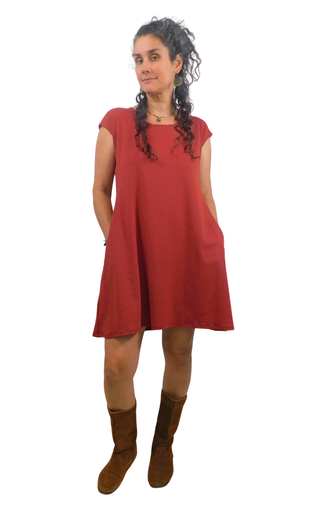 Red Coloured dress with pockets on woman wearing brown boots against a white background