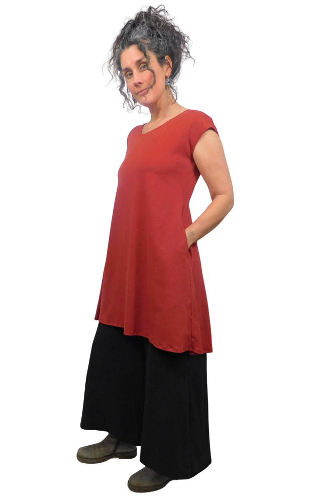 Woman wearing a red top and black pants on a white background