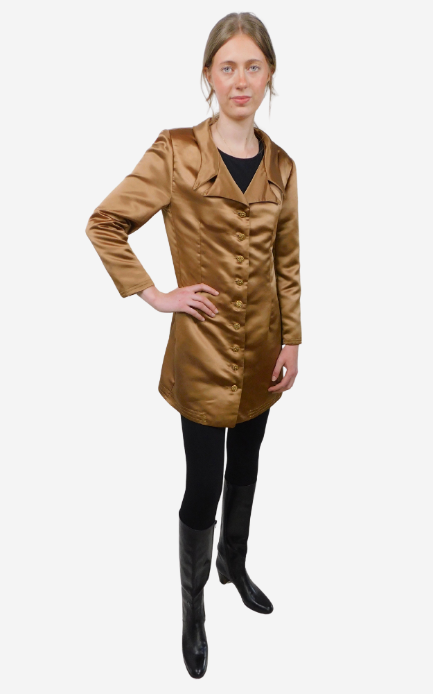 Woman wearing a brown coat and black boots on a white background
