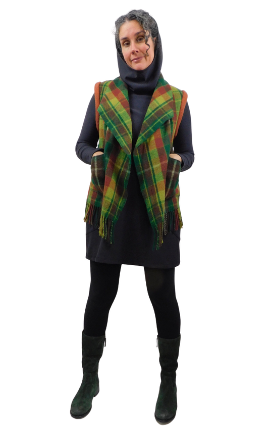 Person wearing a plaid vest over a black outfit on a white background