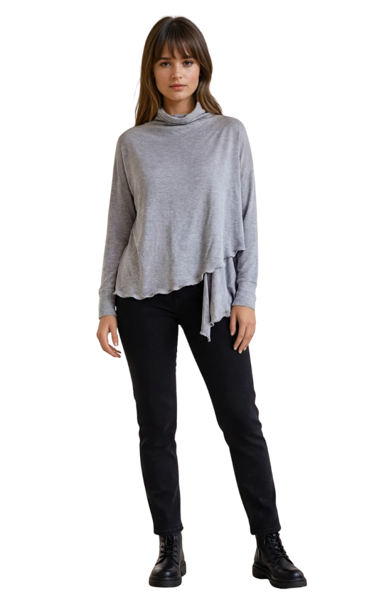 Woman wearing a gray wrap cardigan sweater and black pants on a white background
