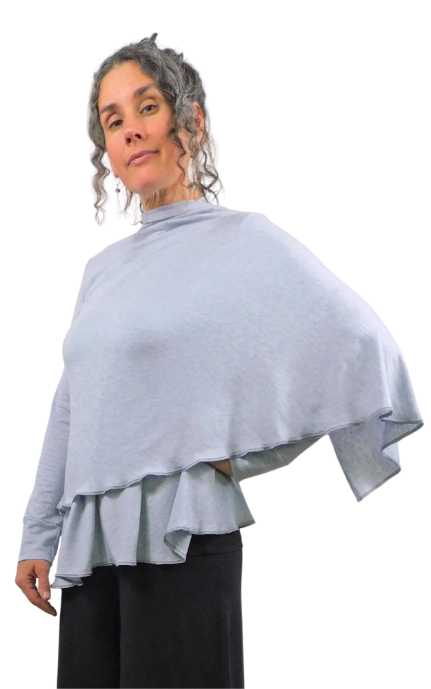 Person wearing a light wrap cardigan over a black outfit on a white background