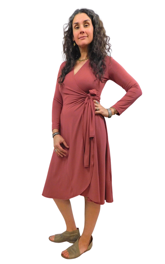 Woman wearing a wine coloured  dress with a white background