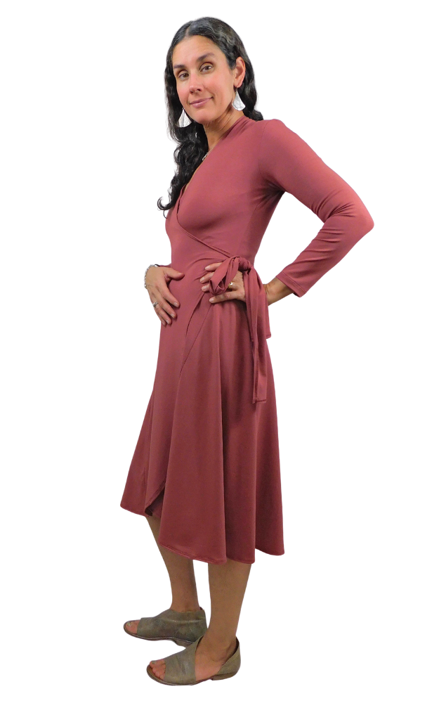 Woman wearing a wine coloured  dress with a white background