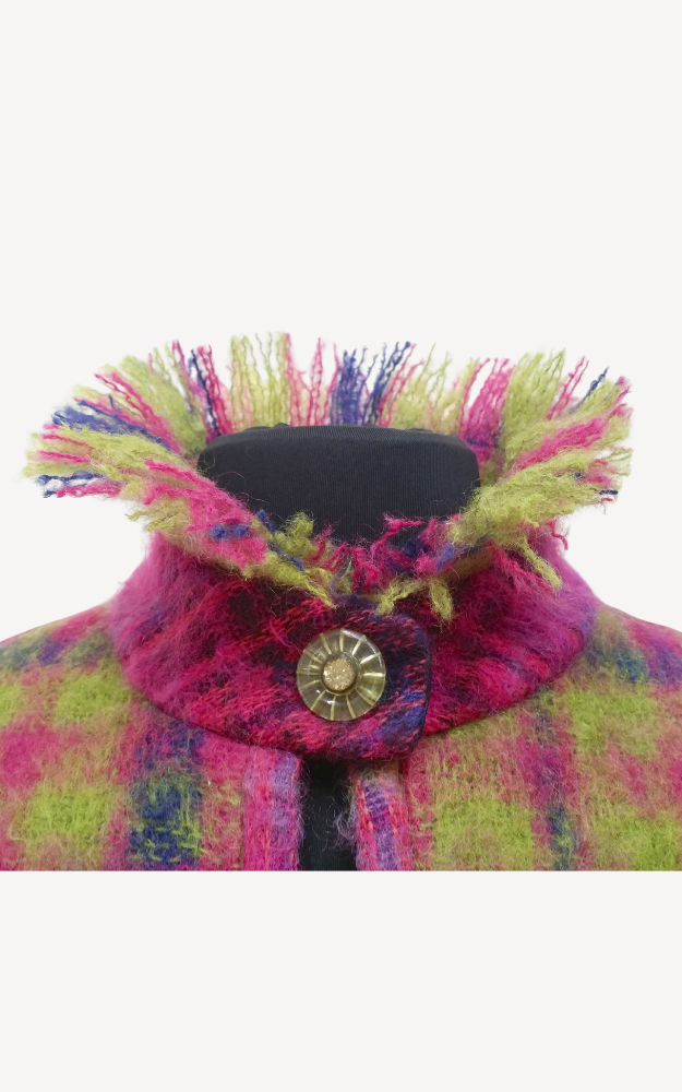 Close-up of a colorful plaid coat  fluffy collar and button on a white background