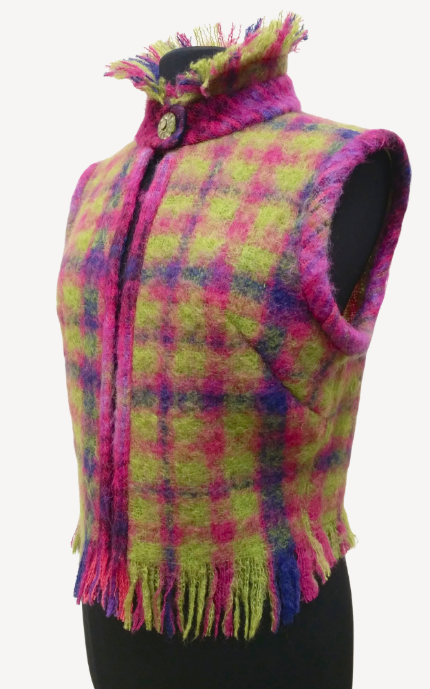 Colorful plaid vest with fringes on a white background