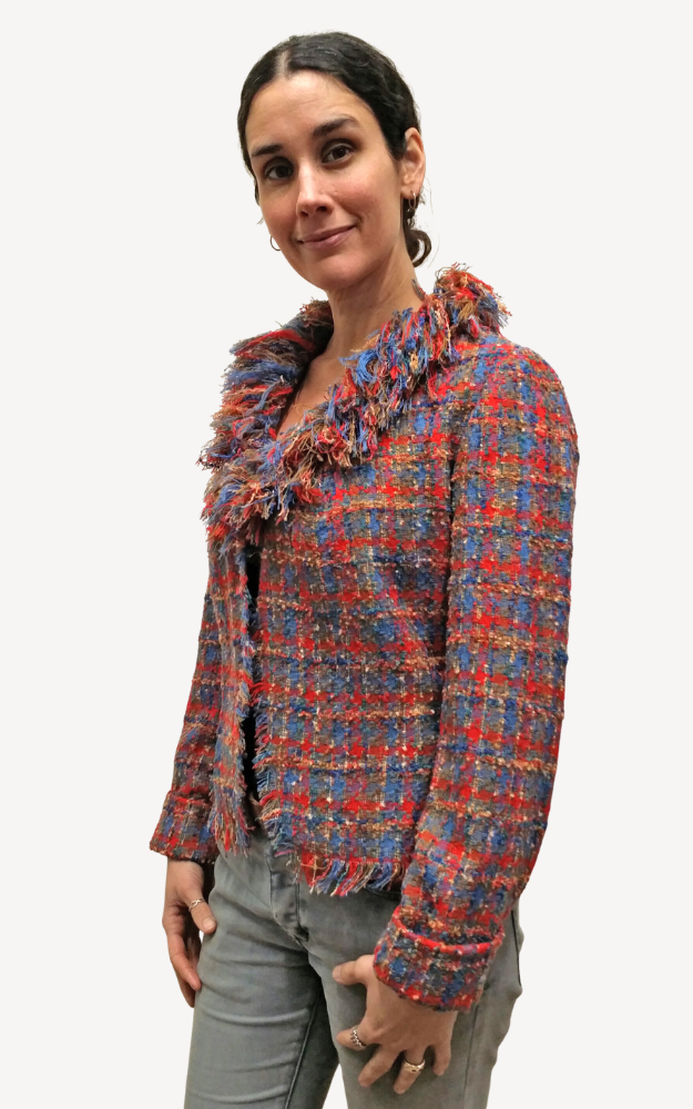 Woman wearing a colorful plaid jacket on a white background