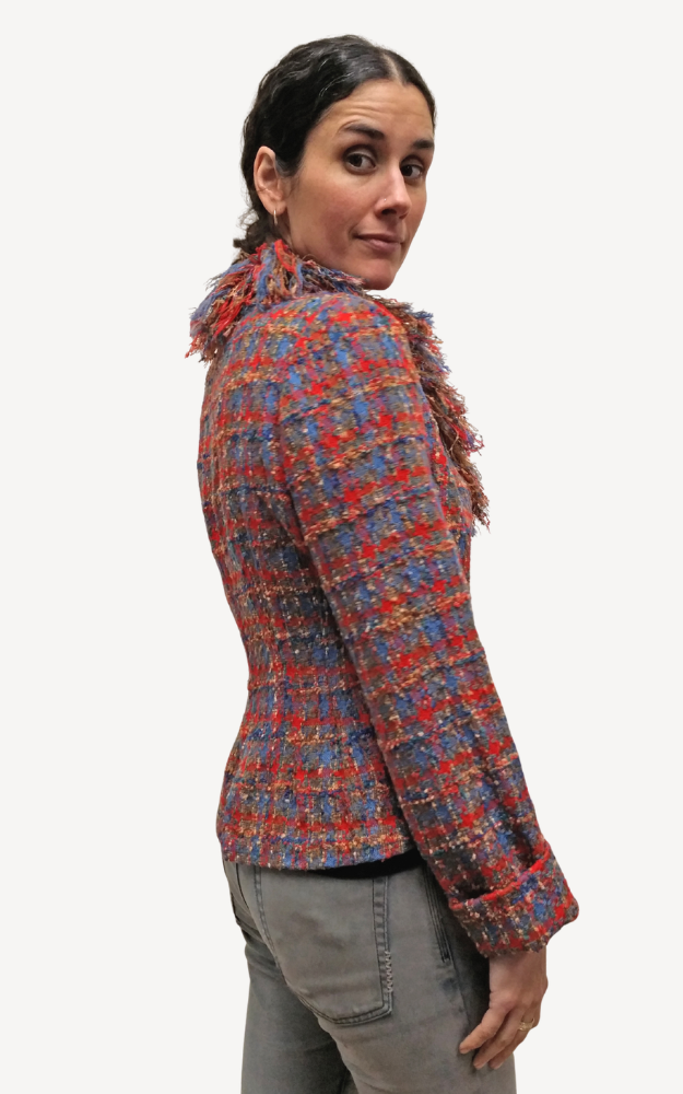 Person wearing a colorful plaid jacket on a white background